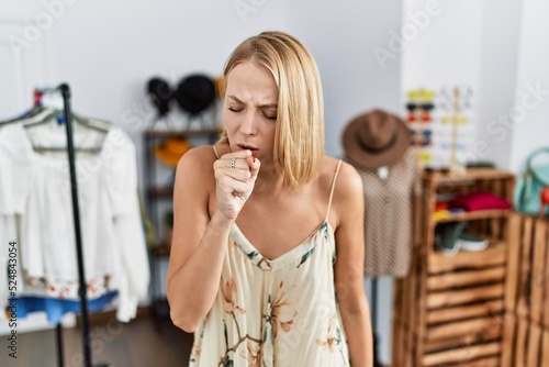 Young caucasian woman at retail shop feeling unwell and coughing as symptom for cold or bronchitis. health care concept.