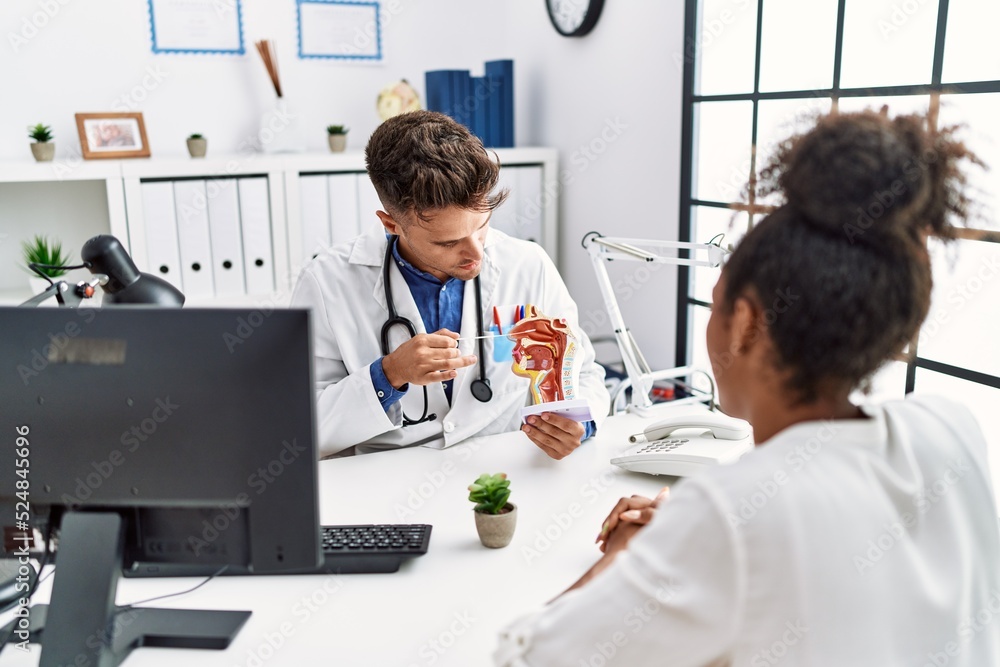 Fototapeta premium Man and woman wearing doctor uniform having otolaryngology consultation at clinic