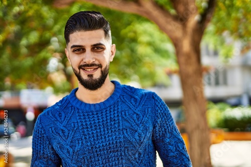 Young arab man smiling confident at park © Krakenimages.com