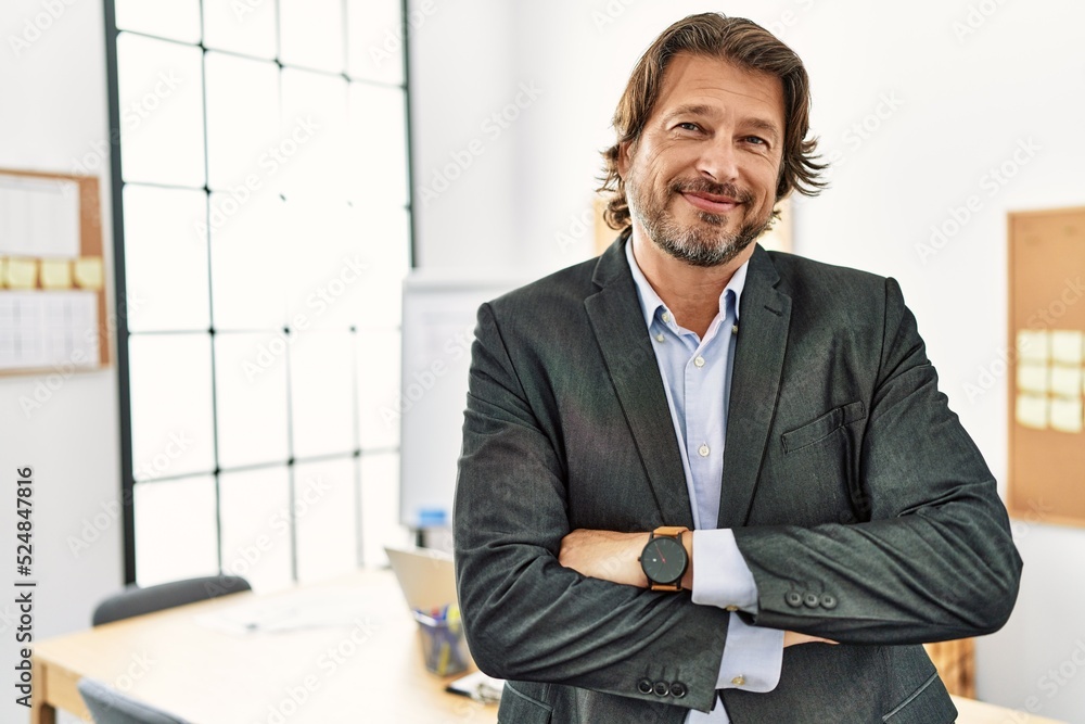 Middle age caucasian man smiling confident with arms crossed gesture at office Middle age caucasian man smiling confident with arms crossed gesture at office