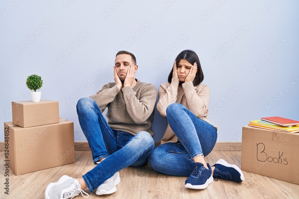 Young couple moving to a new home tired hands covering face, depression and sadness, upset and irritated for problem Young couple moving to a new home tired hands covering face, depression and sadness, upset and irritated for problem