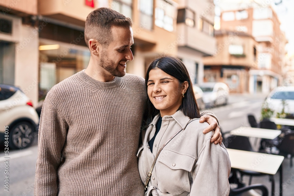 Man and woman couple smiling confident hugging each other standing at street Man and woman couple smiling confident hugging each other standing at street