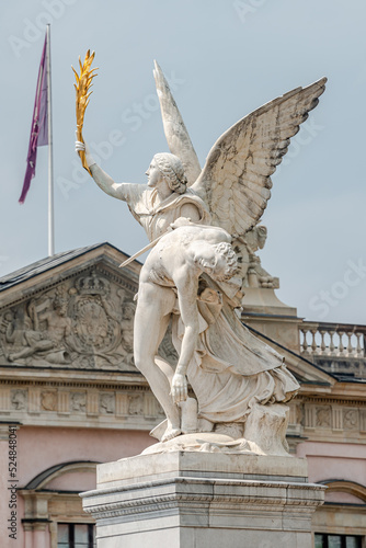 Photo Banner with Roman statue of an angel holding a fighter at war at Schloss Bridge near Berlin Cathedral and Unter den Linden street in historical and museum downtown of Berlin, Germany, with copy space