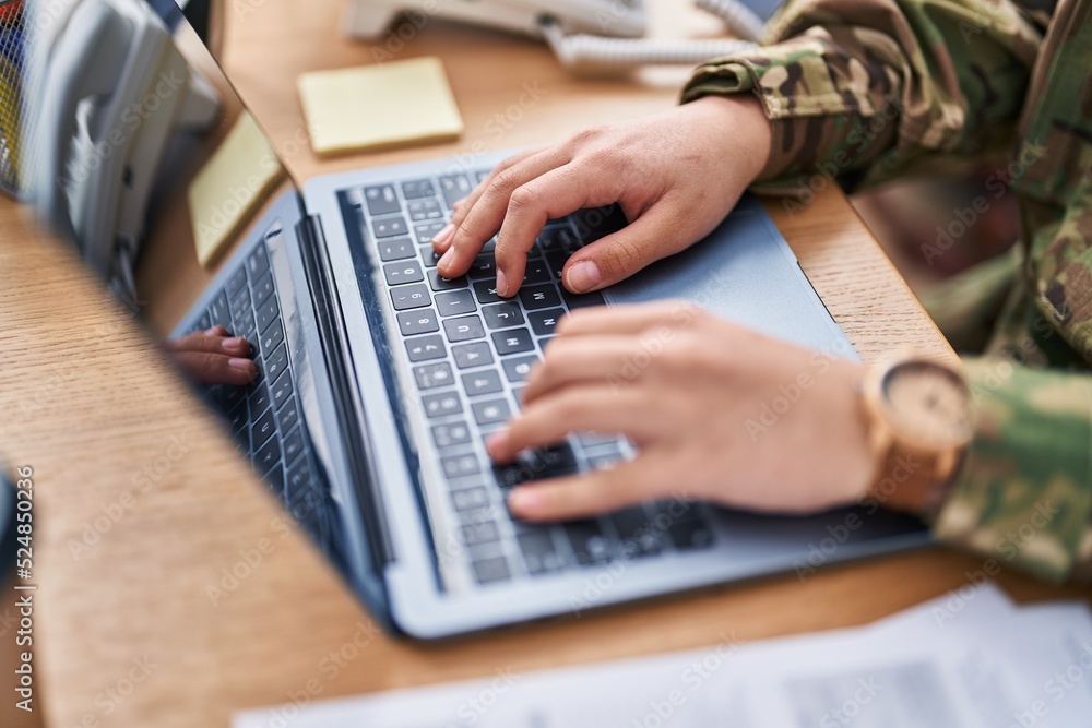 Young hispanic woman army soldier using laptop at office Young hispanic woman army soldier using laptop at office