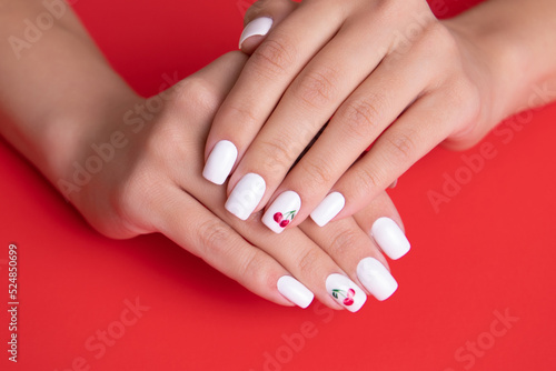 Beautiful female hands with white manicure nails