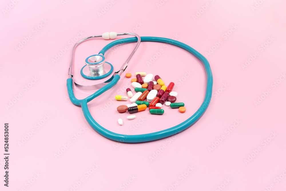 Concept of medicine and health; stethoscope with medicines or pills Concept of medicine and health; stethoscope with medicines or pills