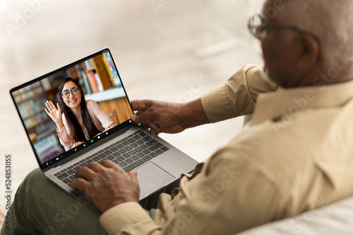 Remote Meeting. Senior Black Man Having Video Call With Young Female On Laptop