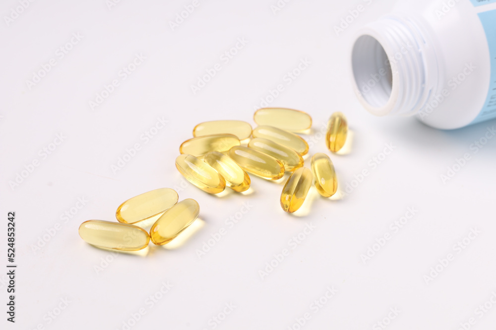 fish oil capsules fish with omega 3 and vitamin D on white backgroud and supplements concept fish oil capsules fish with omega 3 and vitamin D on white backgroud and supplements concept