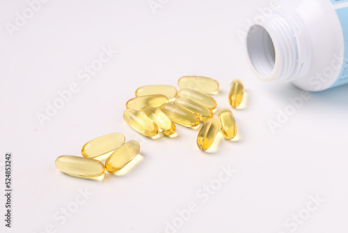 fish oil capsules fish with omega 3 and vitamin D on white backgroud and supplements concept