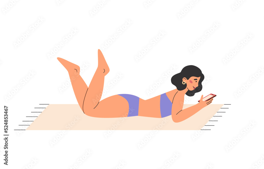 Pretty girl lying on a beach towel with phone and sunbathing Pretty girl lying on a beach towel with phone and sunbathing