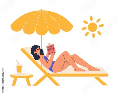 Pretty girl lying on a deckchair, sunbathing and reading book