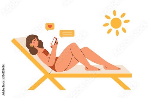 Pretty girl lying on a deckchair, sunbathing and writing a massage