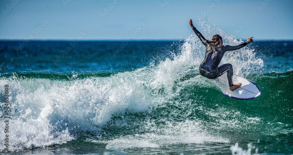 Woman surfing the waves at high speed