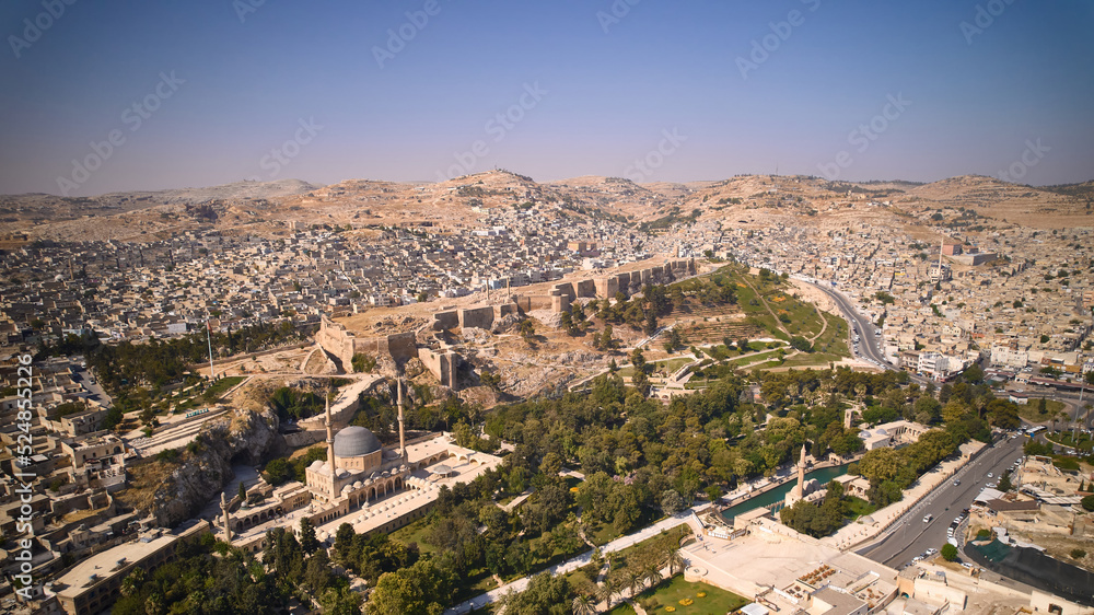 Aerial view of Sanliurfa Castle, rooftops, park around Balikligol and Mevlidi Halil Mosque. Historical and most visited part of Sanliurfa city, southeastern Anatolia, Turkey