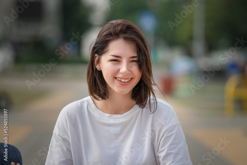 Fotografie Portrait of a young beautiful dark-haired girl in an urban environment