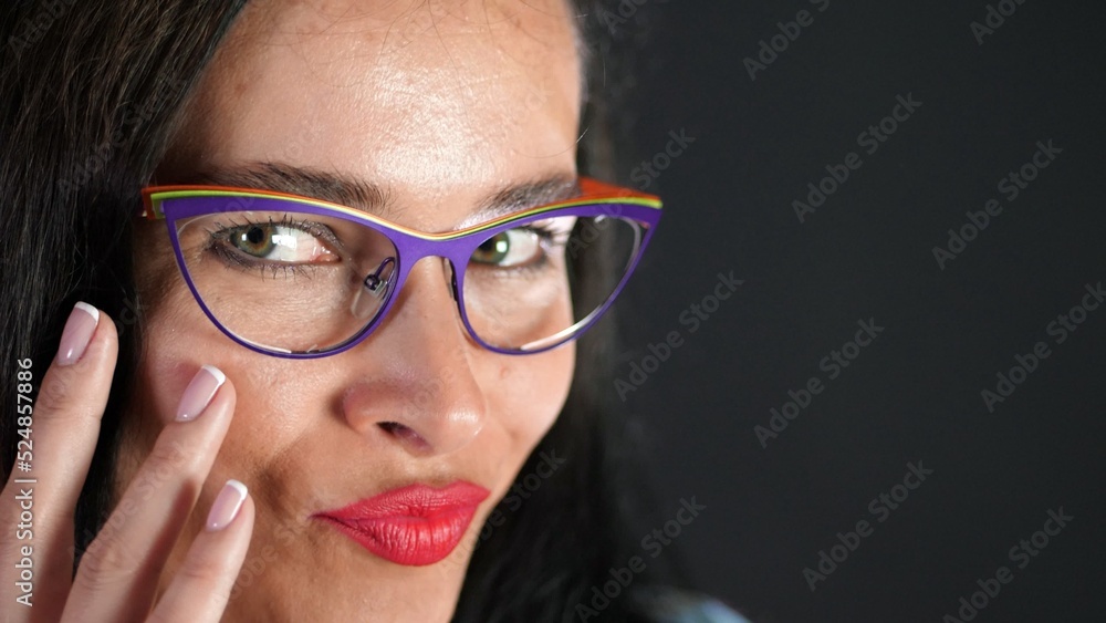 portrait of a sexy brunette woman with red lips who eroticly and playfully tries on stylish glasses, spectacles and looking sexually at camera in studio. dark gray background. High quality photo portrait of a sexy brunette woman with red lips who eroticly and playfully tries on stylish glasses, spectacles and looking sexually at camera in studio. dark gray background. High quality photo