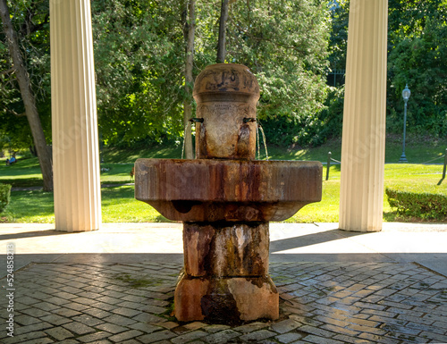 Saratoga Springs, NY - USA - Aug 3, 2022  A closeup of the famous Congress Spring, one of Saratoga’s best-known mineral waters. The spring is covered by an iconic Greek Revival pavilion. photo