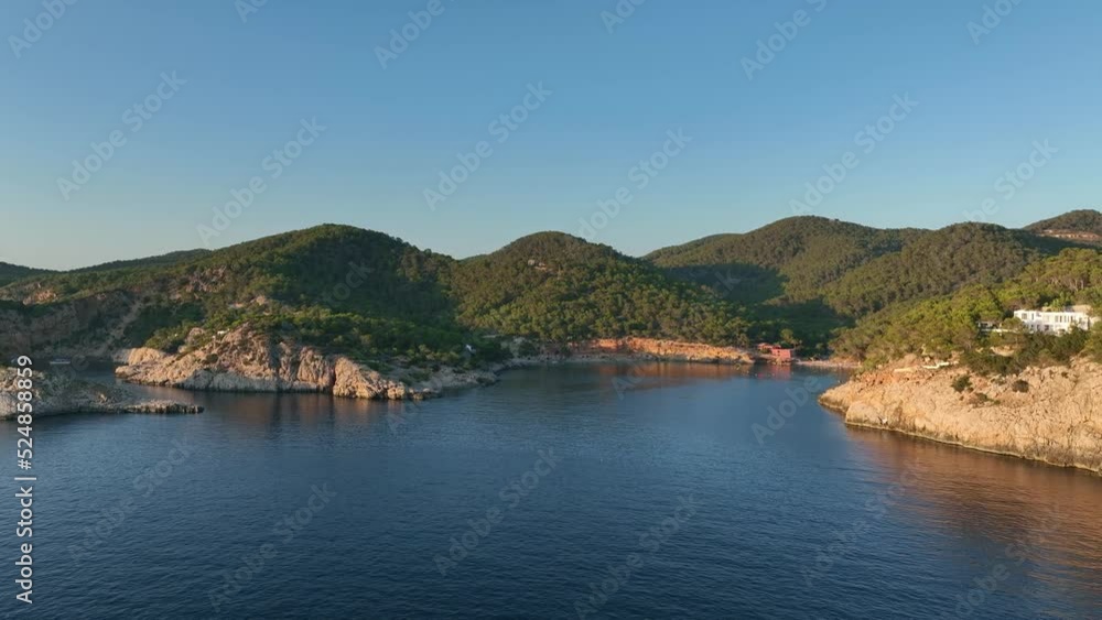 Approach to a small beach located between mountains at sunset. Approach to a small beach located between mountains at sunset.