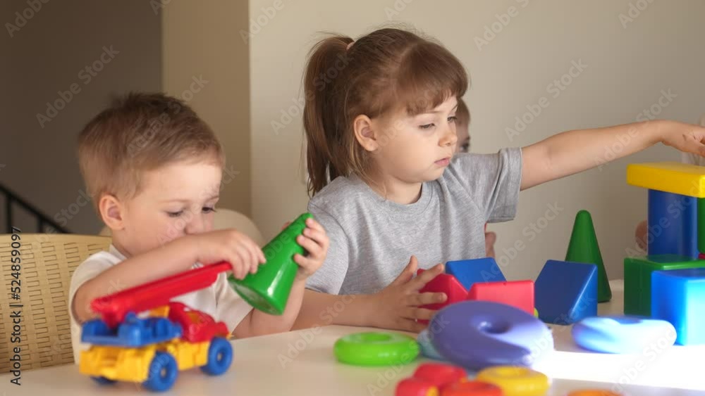 kindergarten. a group of children play toys cubes and cars on the table in kindergarten. kid dream creative happy family preschool education concept. nursery baby toddler home indoor kindergarten. a group of children play toys cubes and cars on the table in kindergarten. kid dream creative happy family preschool education concept. nursery baby toddler home indoor