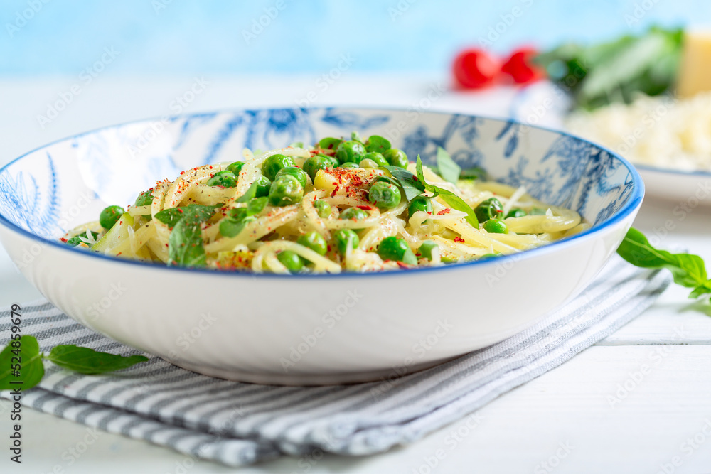 Spaghetti with zucchini and green peas close up. Spaghetti with zucchini and green peas close up.