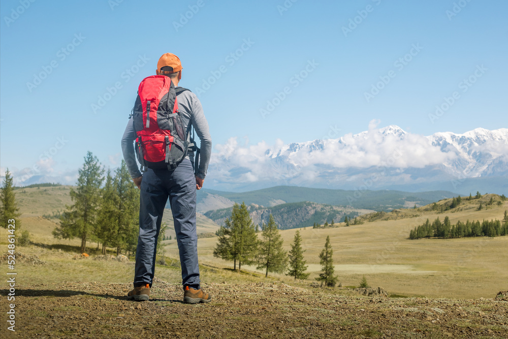 Man solo traveling backpacker hiking in mountains active healthy lifestyle adventure journey.