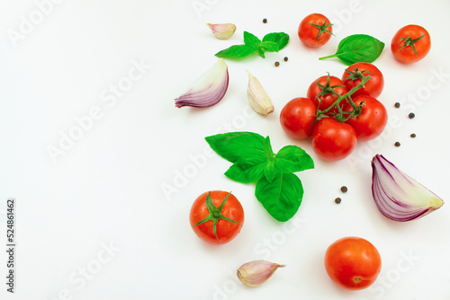 Tomatoes, mushrooms, spices and fresh herbs on a white background. Ingredients for cooking. Copy space