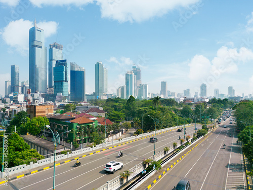 Vehicles passing through road in Jakarta city photo