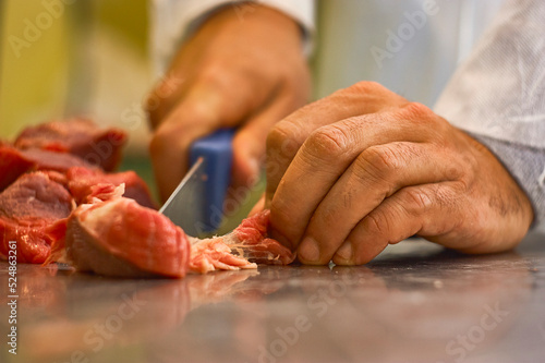 Butcher cleaning the meat from impurities