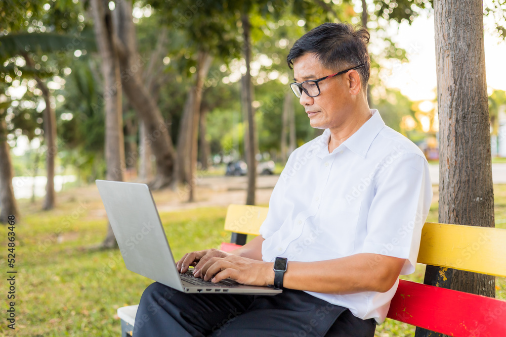 Senior man using laptop computer at the park. Senior man using laptop computer at the park.