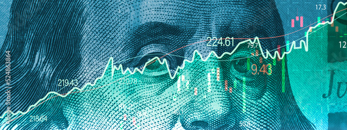 Foto Closeup Benjamin Franklin face on USD banknote with stock market chart graph for currency exchange and global trade forex concept