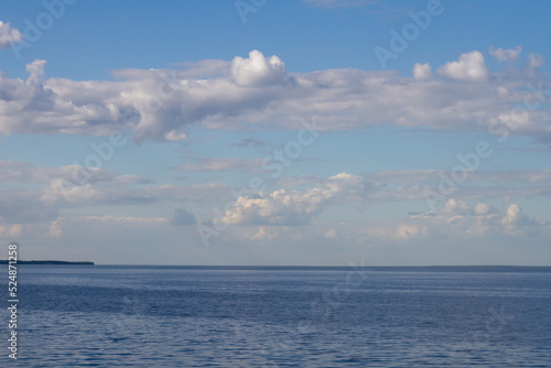 endless blue calm sea or lake with blue sky with white clouds