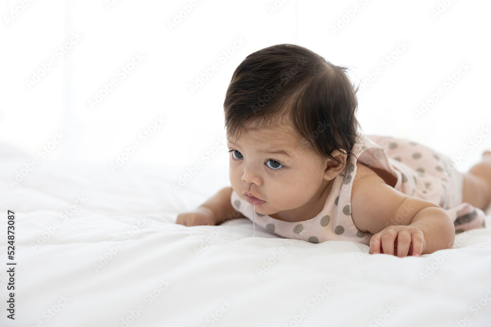 cute baby crawling on bed and drooling from mouth cute baby crawling on bed and drooling from mouth