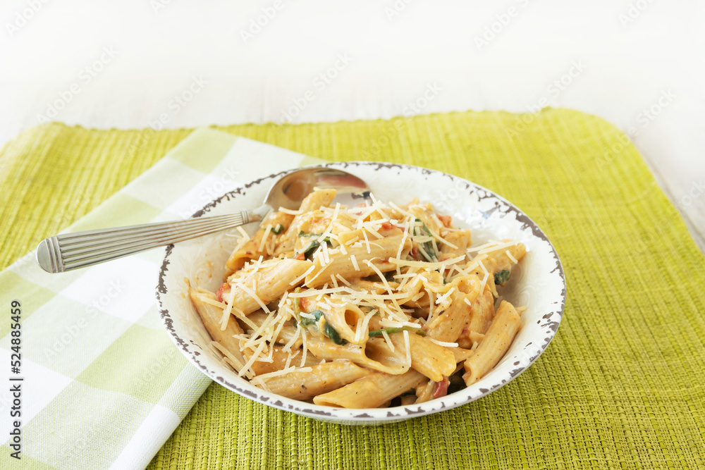 Gluten Free Pasta In White Rustic Bowl With Green Napkin on Green Placemat Gluten Free Pasta In White Rustic Bowl With Green Napkin on Green Placemat
