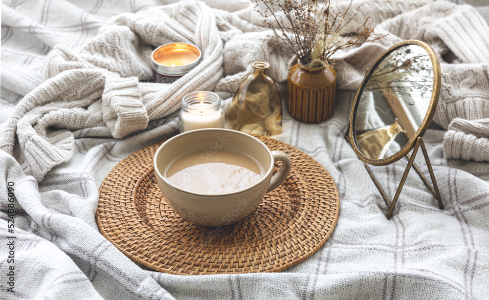Cozy autumn composition with a cup of coffee and candles in bed. Cozy autumn composition with a cup of coffee and candles in bed.
