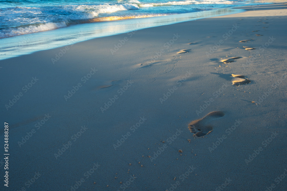 Footprints in the sand. walking by the sea. Footprints on the light sand near the surf line Footprints in the sand. walking by the sea. Footprints on the light sand near the surf line