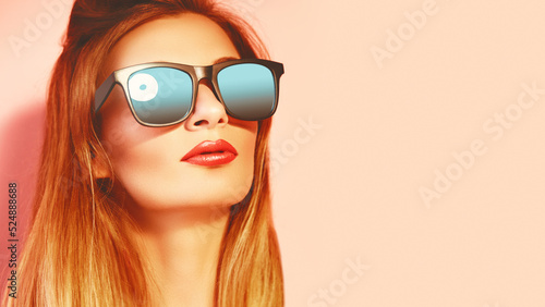 Closeup portrait of fashion woman in sunglasses. Trendy girl in summer style on pink. Eyewear  glasses. Toned photo.
