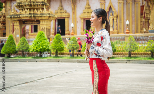 Beautiful Asian girl at big Buddhist temple dressed in traditional costume © romaset