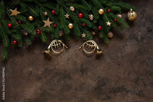 Christmas background with fir tree branches, Christmas decoration – stars, balls, trumpets, cones. Top view, close up.