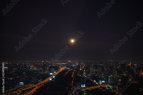 Bangkok.thailand.16.04.2022 Bangkok cityscape view with beautiful full moon  from top of building in bangkok city