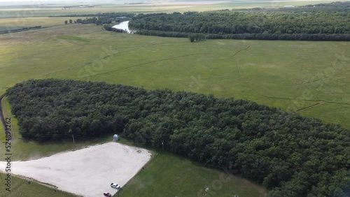 Flying over the forest and Assiniboine River at Beaudry Provincial Park, Manitoba on a sunny summer day