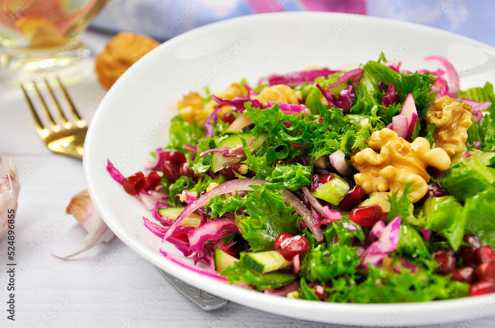 Healthy vegetarian Salad with pomegranate, walnuts and lettuce leaves. Healthy vegetarian Salad with pomegranate, walnuts and lettuce leaves.