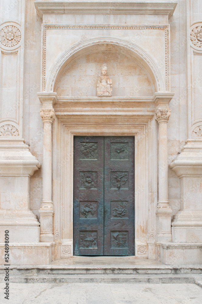 Facade of the old church with the metal door in Hvar town, Croatia, famous travel destination