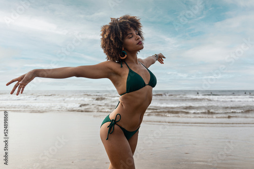 beautiful young black african girl in bikini happy on the beach