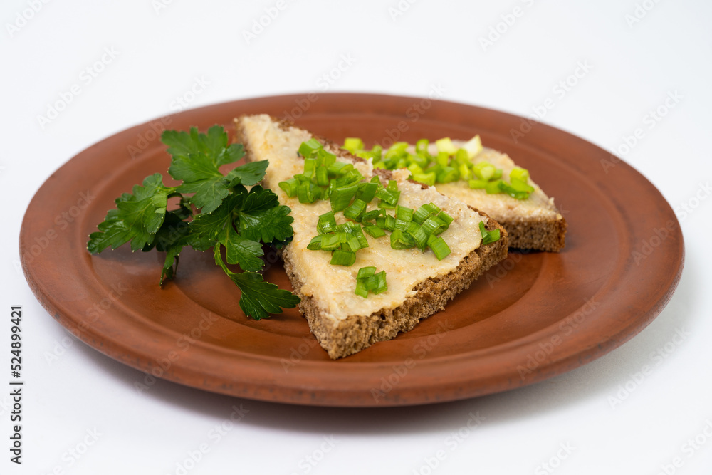a slice of bread smeared with lard with green onions and parsley a slice of bread smeared with lard with green onions and parsley