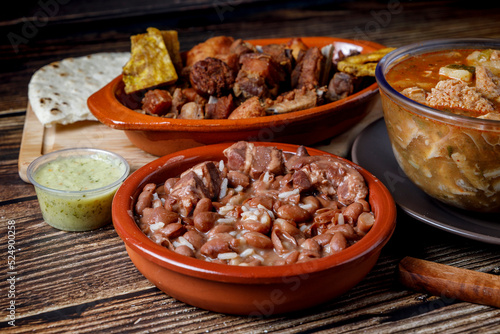 Variety of traditional Colombian food with beans, picada, tripe soup, arepas and avocado