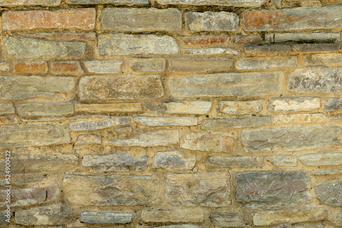 Solid yellow and beige stone wall. Stone background.
