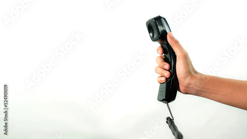 Hand holding office phone in white background.