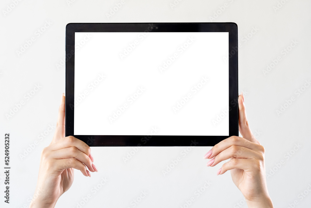 Digital mockup. Online advertising. Internet technology. Female hands holding tablet computer with blank screen isolated white. Digital mockup. Online advertising. Internet technology. Female hands holding tablet computer with blank screen isolated white.