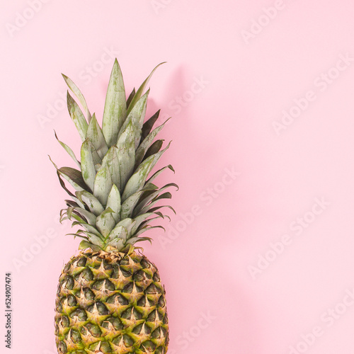 Fresh pineapple on on bright pink background. Flat lay