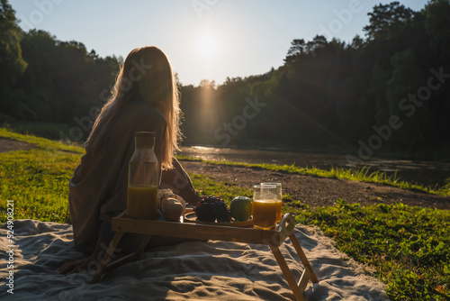 Wallpaper Mural Young woman on a picnic in the morning enjoying the sunrise Torontodigital.ca